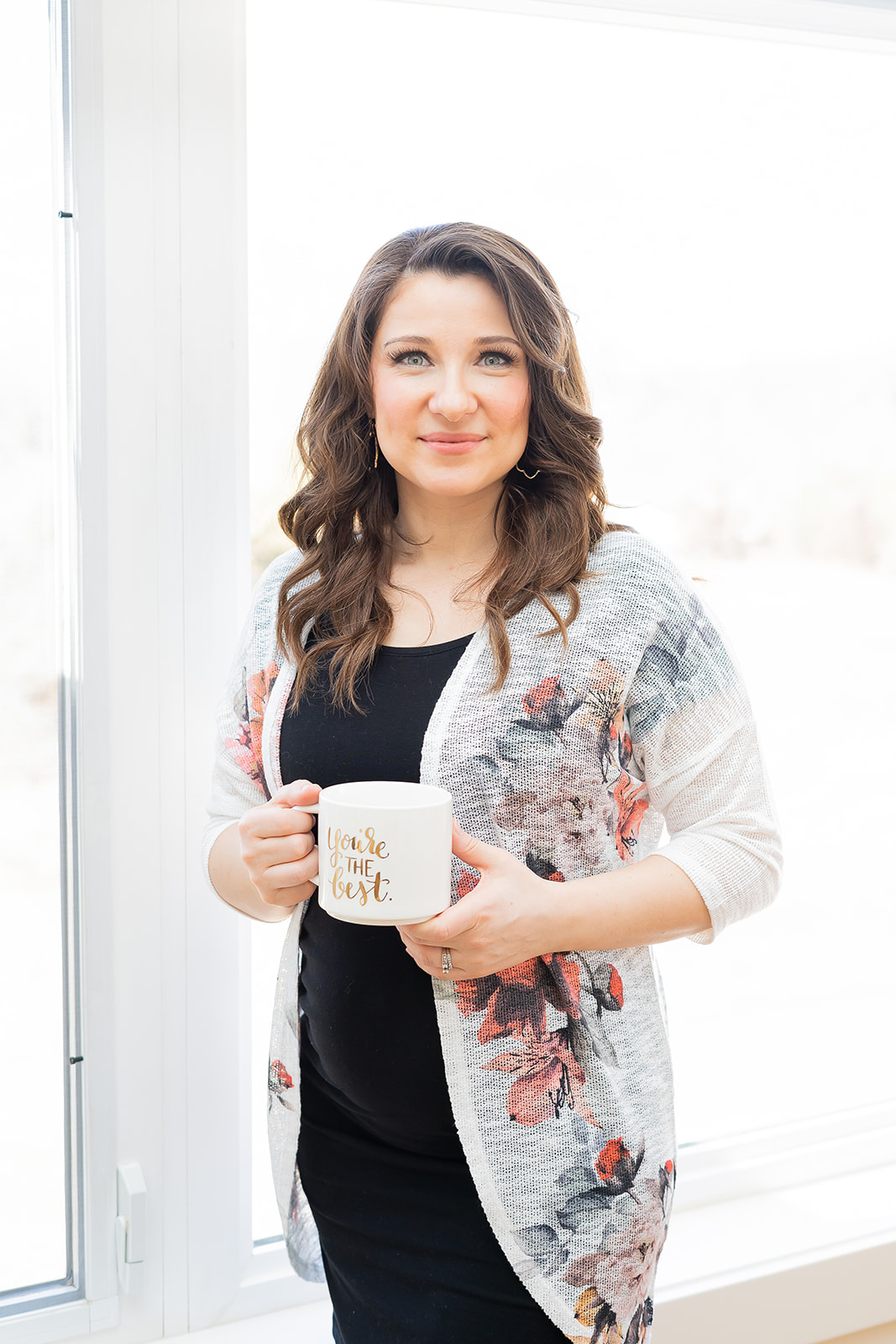 A business owner standing with mug during a light and airy branding photography session in Rockville, Maryland. 