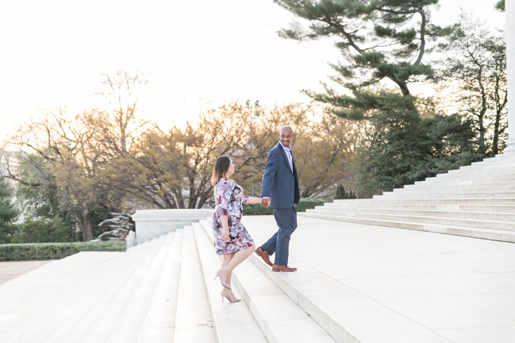 Engagement session in Washington DC monuments. Proposal Tips. Couple holding hands walking up the steps during sunset. 