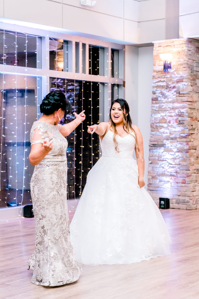 Bride and stepmother dancing at wedding party